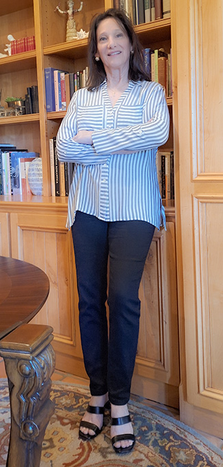 image of Gwenn at bookcase at Allyson's summer2026